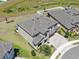 Aerial shot of a beautiful home featuring a stone facade, three-car garage, and manicured landscaping at 12795 Fisherville Way, Riverview, FL 33579