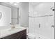 Modern bathroom featuring sleek vanity, glass-enclosed shower, and white tile, offering a clean and luxurious space at 12795 Fisherville Way, Riverview, FL 33579