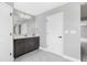 Bright bathroom with marble flooring, gray vanity, white door, and modern finishes creates a clean and elegant space at 12795 Fisherville Way, Riverview, FL 33579
