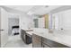 Bright bathroom featuring dual vanities with quartz countertops and stylish tile flooring, adjacent to bedroom at 12795 Fisherville Way, Riverview, FL 33579
