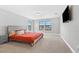 Well lit bedroom with neutral walls, carpet, and a view of the street at 12795 Fisherville Way, Riverview, FL 33579