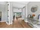 Bright hallway featuring hardwood floors and a view into the living room at 12795 Fisherville Way, Riverview, FL 33579
