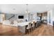 Modern open concept with kitchen island, ample countertop seating, and a view into the living area at 12795 Fisherville Way, Riverview, FL 33579