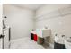 Functional laundry room with a utility sink, ample storage shelves, a modern washer/dryer, and marble tile flooring at 12795 Fisherville Way, Riverview, FL 33579