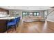 Open living room featuring a large sectional sofa, island with blue bar stools, and sliding glass doors leading to outdoor views at 12795 Fisherville Way, Riverview, FL 33579