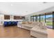 Open floor plan seamlessly connects the kitchen with a large sectional sofa and sliding glass doors offering backyard views at 12795 Fisherville Way, Riverview, FL 33579