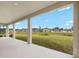 Covered patio offering a view of the expansive backyard and surrounding neighborhood on a clear, sunny day at 12795 Fisherville Way, Riverview, FL 33579