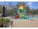 Vibrant splash pad with colorful play structures and ample seating under the trees at 12795 Fisherville Way, Riverview, FL 33579