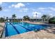 Beautiful community swimming pool with blue skies and clubhouse in the background at 12795 Fisherville Way, Riverview, FL 33579