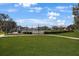 Well-maintained tennis and basketball courts surrounded by green lawns and landscaping at 12795 Fisherville Way, Riverview, FL 33579