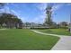 Scenic view of tennis courts on a sunny day, framed by lush greenery and clear blue skies at 12795 Fisherville Way, Riverview, FL 33579