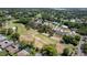 Aerial view of a neighborhood backing onto a golf course with mature trees and well-maintained landscaping at 12904 Teakwood Ln, Hudson, FL 34667