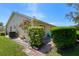 Backyard showing landscaping, with a brick paver area, and mature plants and trees at 12904 Teakwood Ln, Hudson, FL 34667
