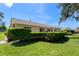 The backyard features a well-maintained lawn, and mature landscaping around the perimeter of the property at 12904 Teakwood Ln, Hudson, FL 34667