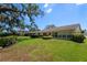 Expansive backyard offering beautiful landscaping, mature trees, and a well-maintained lawn at 12904 Teakwood Ln, Hudson, FL 34667