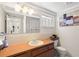 Bright bathroom with neutral color palette and shuttered window at 12904 Teakwood Ln, Hudson, FL 34667