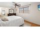 Bedroom featuring a ceiling fan, dark wood dresser and flooring creating a cozy retreat at 12904 Teakwood Ln, Hudson, FL 34667