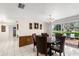 Dining room with glass table and view of the outdoor patio through sliding glass doors for seamless transition at 12904 Teakwood Ln, Hudson, FL 34667