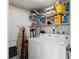 A view of the laundry room area with washer, dryer and storage shelves and cleaning supplies at 12904 Teakwood Ln, Hudson, FL 34667