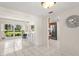 Bright living room featuring tile floors, a breakfast bar and seamless entry into an adjacent updated kitchen at 12904 Teakwood Ln, Hudson, FL 34667