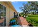 Beautiful brick patio with outdoor seating and lush landscaping, offering a serene outdoor living space at 12904 Teakwood Ln, Hudson, FL 34667