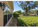 Yard featuring manicured landscaping, mature trees, a stone walkway, and an exterior home view at 12904 Teakwood Ln, Hudson, FL 34667