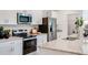 Spacious kitchen featuring stainless steel appliances, granite countertops, and a view of the pantry at 13490 Tropical Breeze Way, Hudson, FL 34669