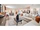 Spacious living area seamlessly connects to the dining and kitchen, featuring modern decor and abundant natural light at 13490 Tropical Breeze Way, Hudson, FL 34669