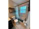 Cozy bathroom featuring tile flooring, a shower/tub, and natural light at 1407 College Park Ln, Tampa, FL 33612
