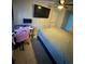 Cozy bedroom with a TV, desk, gaming chair and a ceiling fan at 1407 College Park Ln, Tampa, FL 33612