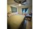 Comfortable bedroom featuring a ceiling fan, tile flooring, and natural light from two windows at 1407 College Park Ln, Tampa, FL 33612