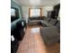Cozy living room featuring a large sectional couch, TV, and tile flooring at 1407 College Park Ln, Tampa, FL 33612