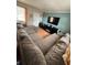 Comfortable living room with a large sectional couch, TV, and bright natural light at 1407 College Park Ln, Tampa, FL 33612