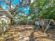 An expansive backyard features a playground and storage shed, offering ample space for recreation and storage at 14350 11Th St, Dade City, FL 33523