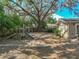 Spacious backyard features a play structure, with a large tree, providing a serene setting for outdoor enjoyment at 14350 11Th St, Dade City, FL 33523