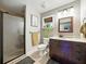 Bathroom featuring a glass-enclosed shower, dark wood vanity, and modern fixtures at 14350 11Th St, Dade City, FL 33523
