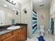 Bright bathroom with granite countertop, vanity, framed mirror and stylish blue accents at 14350 11Th St, Dade City, FL 33523