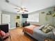 Comfortable bedroom featuring hardwood floors, neutral colors, and a view to an adjacent bathroom at 14350 11Th St, Dade City, FL 33523