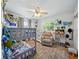 Shared bedroom showcasing a bunk bed, crib, soft chair and plenty of space for play at 14350 11Th St, Dade City, FL 33523