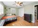 Cozy bedroom features hardwood floors, a ceiling fan, and ample storage at 14350 11Th St, Dade City, FL 33523