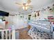 Shared bedroom featuring a bunk bed, crib, plush chair and a whimsical gallery wall at 14350 11Th St, Dade City, FL 33523