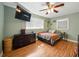 Inviting bedroom with hardwood floors, a large window, and a ceiling fan at 14350 11Th St, Dade City, FL 33523