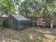 Backyard chicken coop with wire fencing and a small wooden house for poultry, offering a rural lifestyle at 14350 11Th St, Dade City, FL 33523