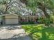 Charming single-story home featuring a manicured lawn, stone accents, and a well-maintained exterior at 14350 11Th St, Dade City, FL 33523