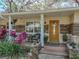 Close-up of front porch showcasing stone details, number of the house, seating and a decorative door at 14350 11Th St, Dade City, FL 33523