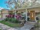 Inviting front porch with stone accents, a cozy seating area, and a beautifully crafted wooden door at 14350 11Th St, Dade City, FL 33523