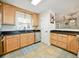 Bright kitchen featuring wooden cabinets, stainless steel appliances, and dark countertops at 14350 11Th St, Dade City, FL 33523