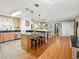 Well-equipped kitchen features stainless steel appliances and an island with bar seating at 14350 11Th St, Dade City, FL 33523