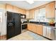 Spacious kitchen equipped with stainless steel appliances, light cabinets and dark countertops at 14350 11Th St, Dade City, FL 33523