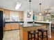 Kitchen with breakfast bar and view into a bright dining area at 14350 11Th St, Dade City, FL 33523